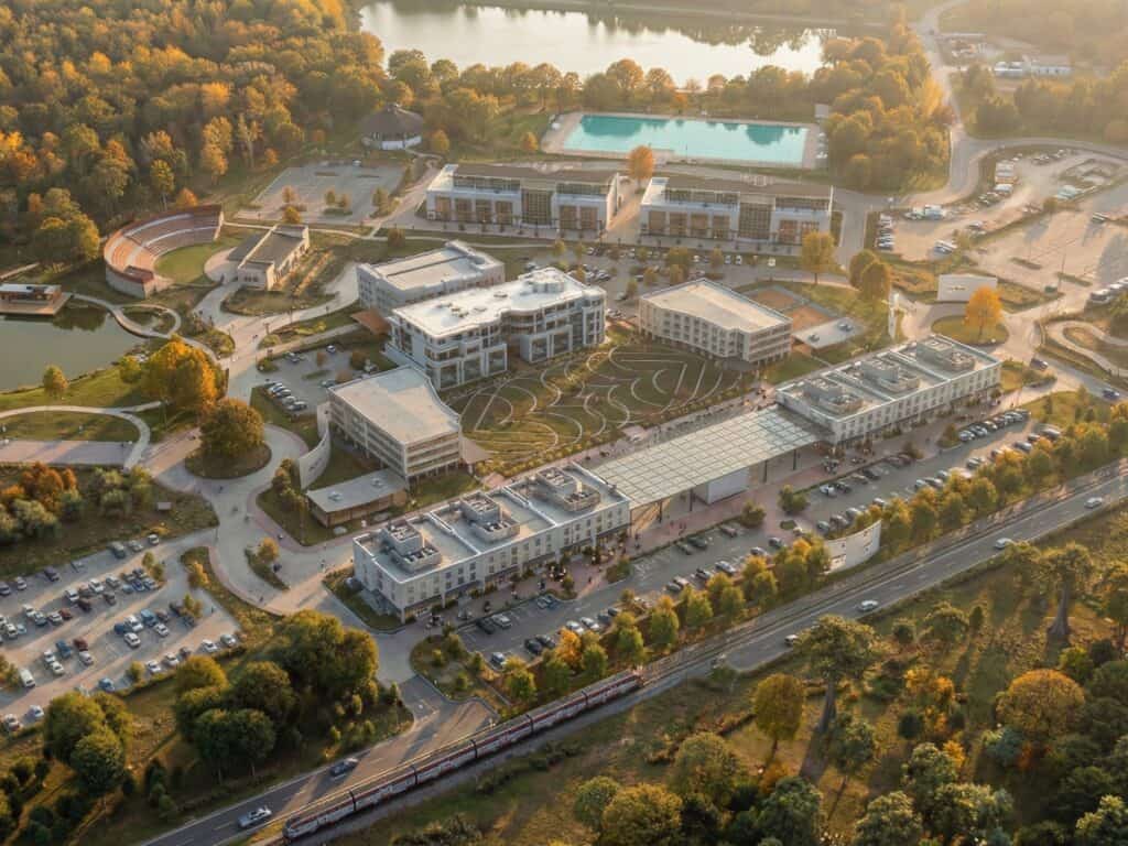 Autumn aerial of the Lovejoy Master Plan downtown core, with the community center, paths, and ponds.